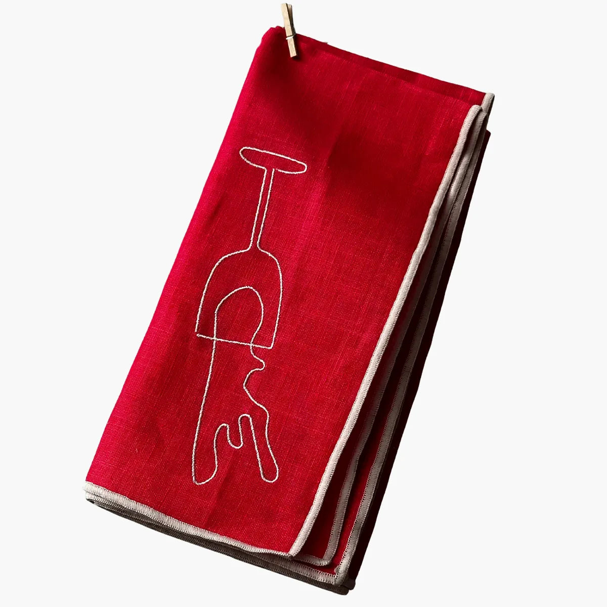 Red napkin with a white wine glass design on a white background