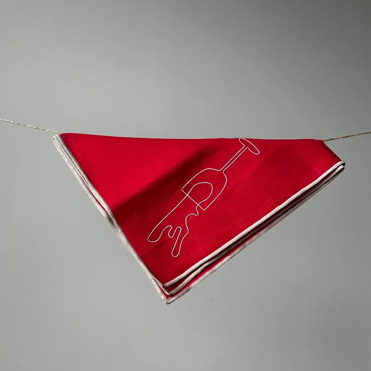 Red napkin with white design on a gray background