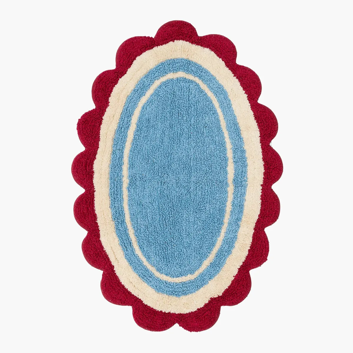 Blue oval bathmat with red scalloped edge on a white background
