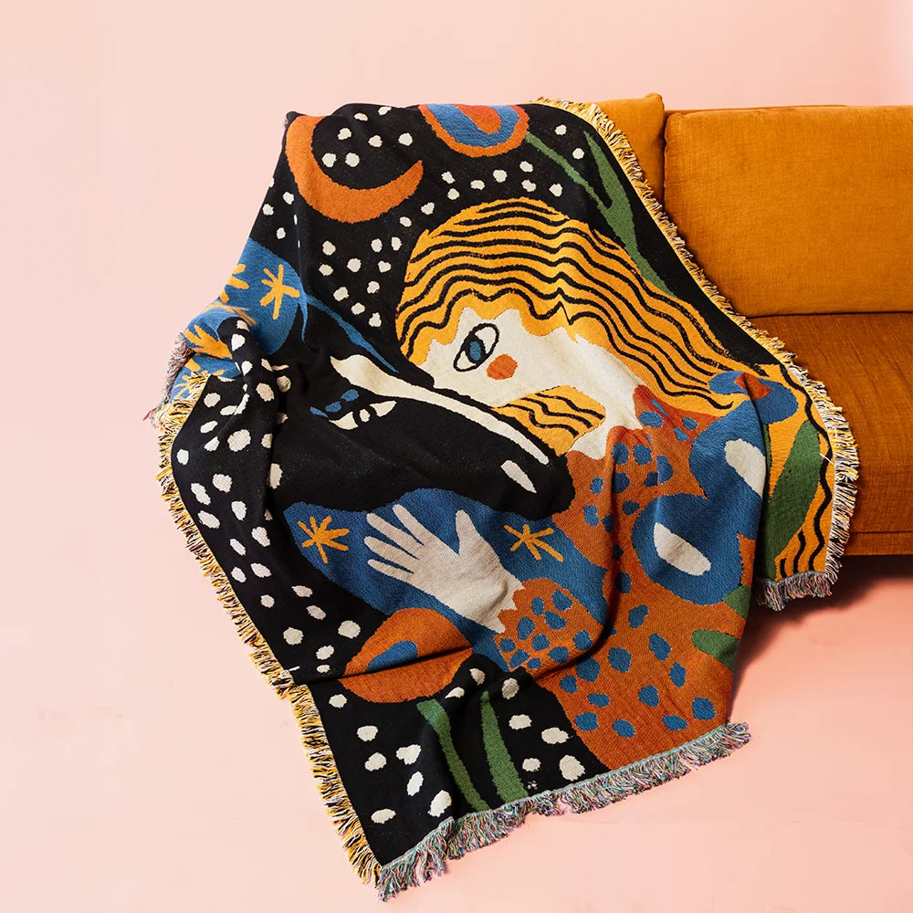Alma Throw - Slowdown Studio. Colorful woven throw blanket tapestry with abstract folk design of a woman, horse, stars, and flowers on a black background