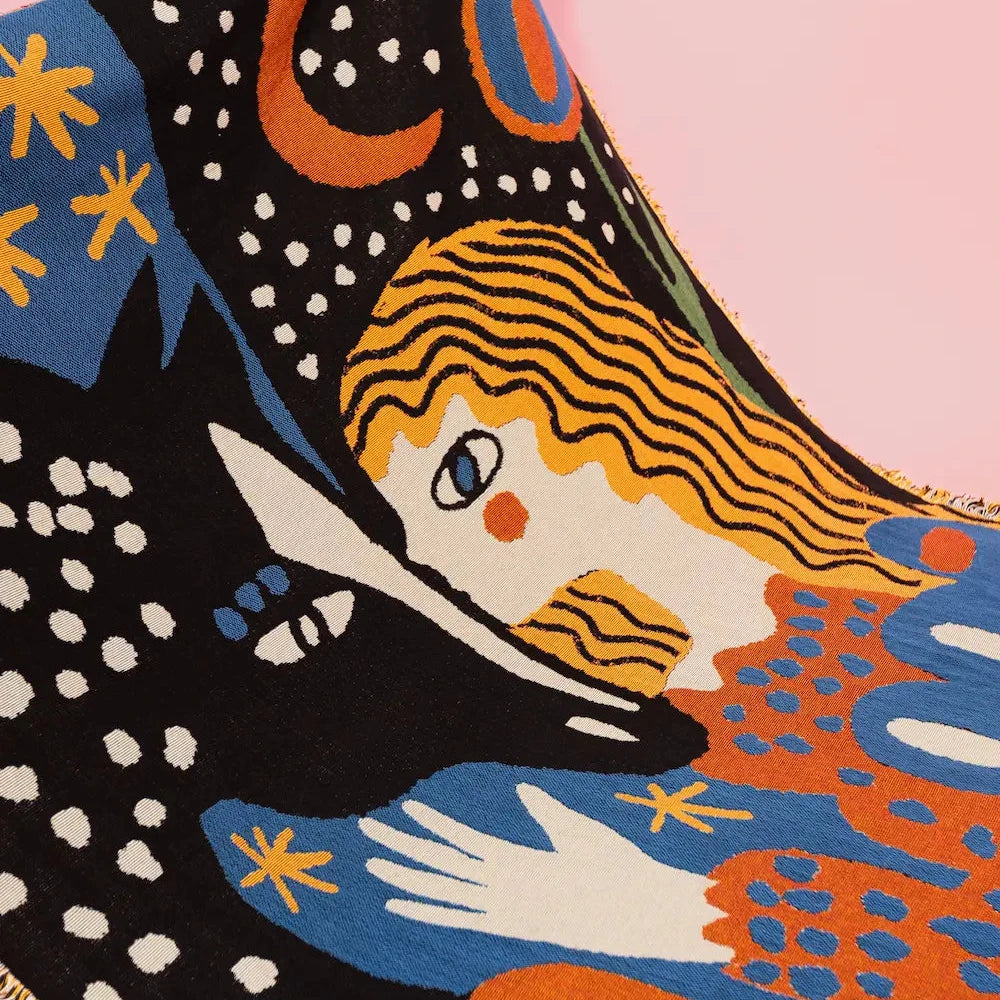 Colorful tapestry with abstract design featuring a woman, moon, and stars on a pink background