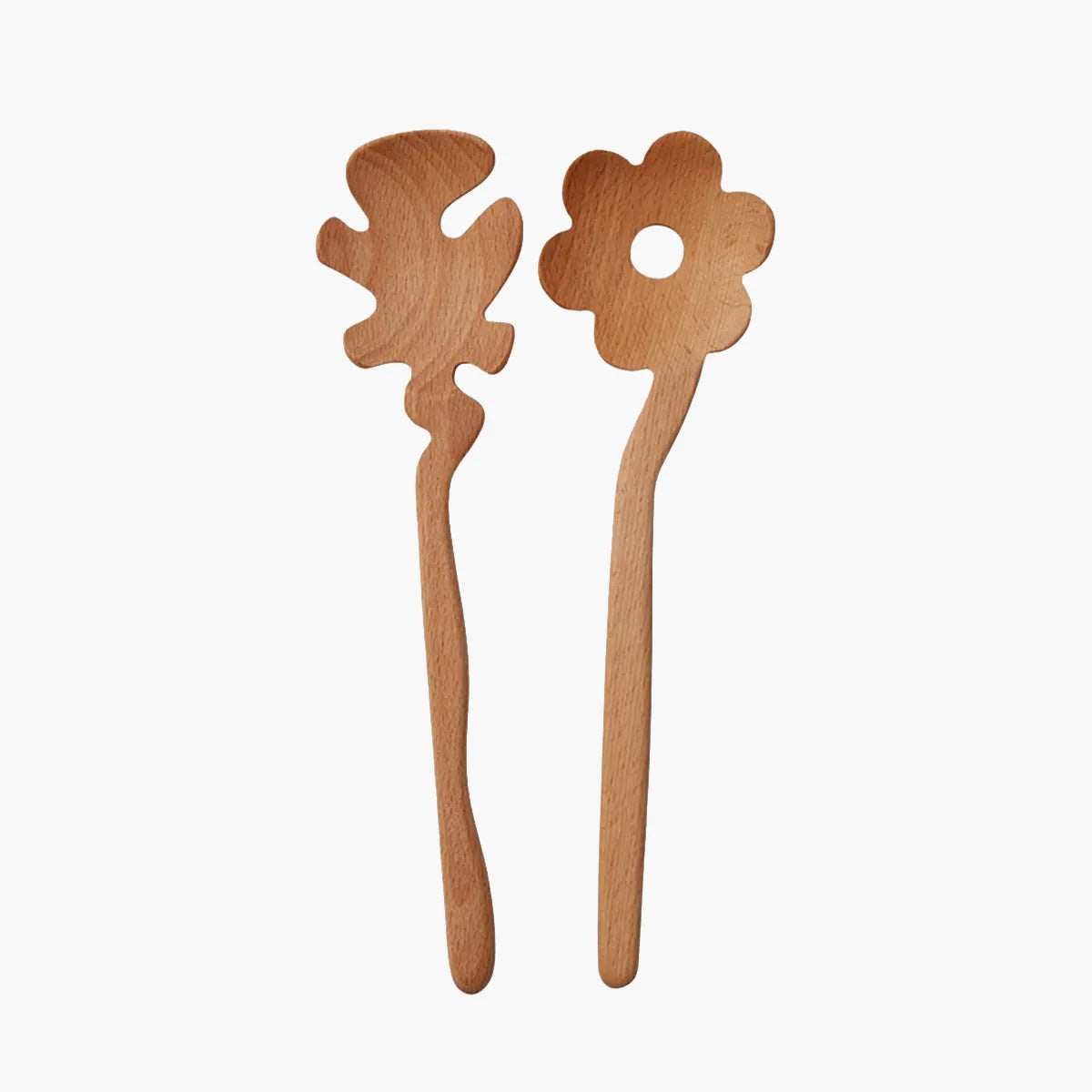 Two light natural wood flower-shaped Serving Friends spoons from Areaware, photographed against a solid off-white background.