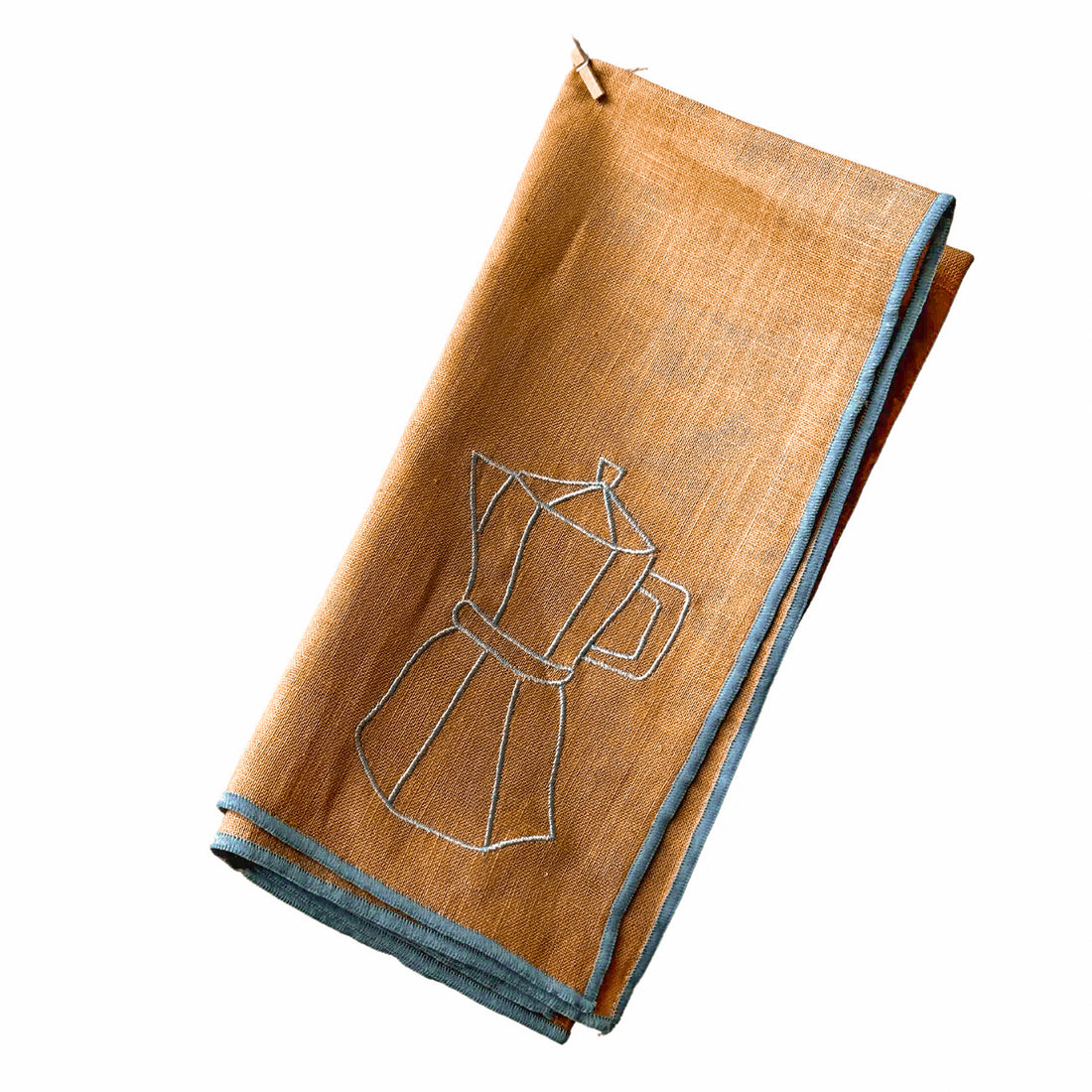 Folded brown napkin with blue embroidery on a white background