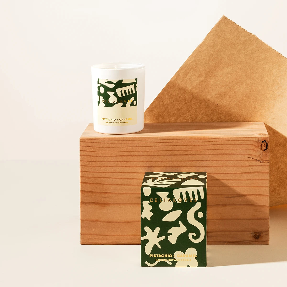 Pistachio &amp; Caramel Candle and packaging with painterly design on a beige background