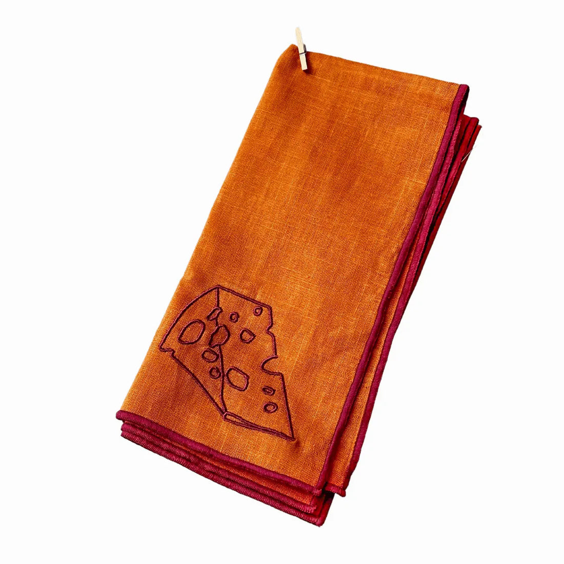 Orange napkin with a cheese design on a white background