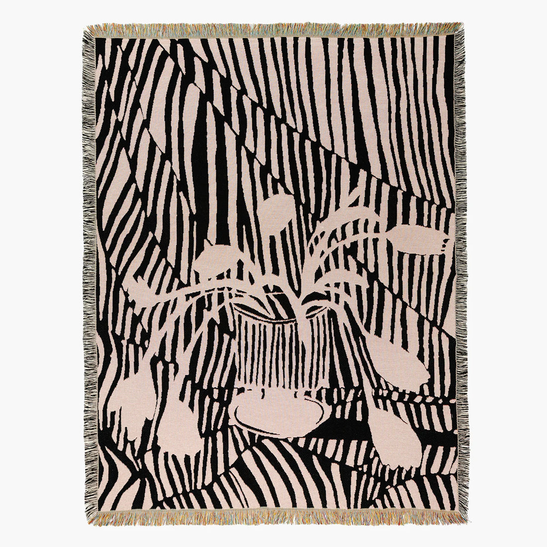 A woven throw blanket with a black and beige zebra-stripe pattern and a central illustration of a potted flower plant, finished with a fringed border.
