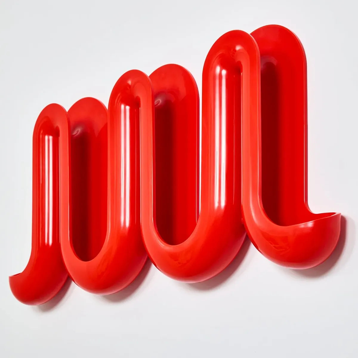 A red, wavy, three-dimensional Heller Swell Wall Catchall on a clean white background.