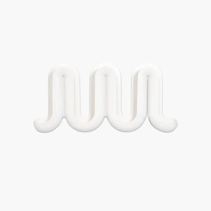 A white, wavy, three-dimensional Heller Swell Wall Catchall on a plain white background.