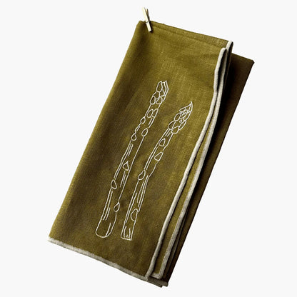 Green napkin with white asparagus design on a white background