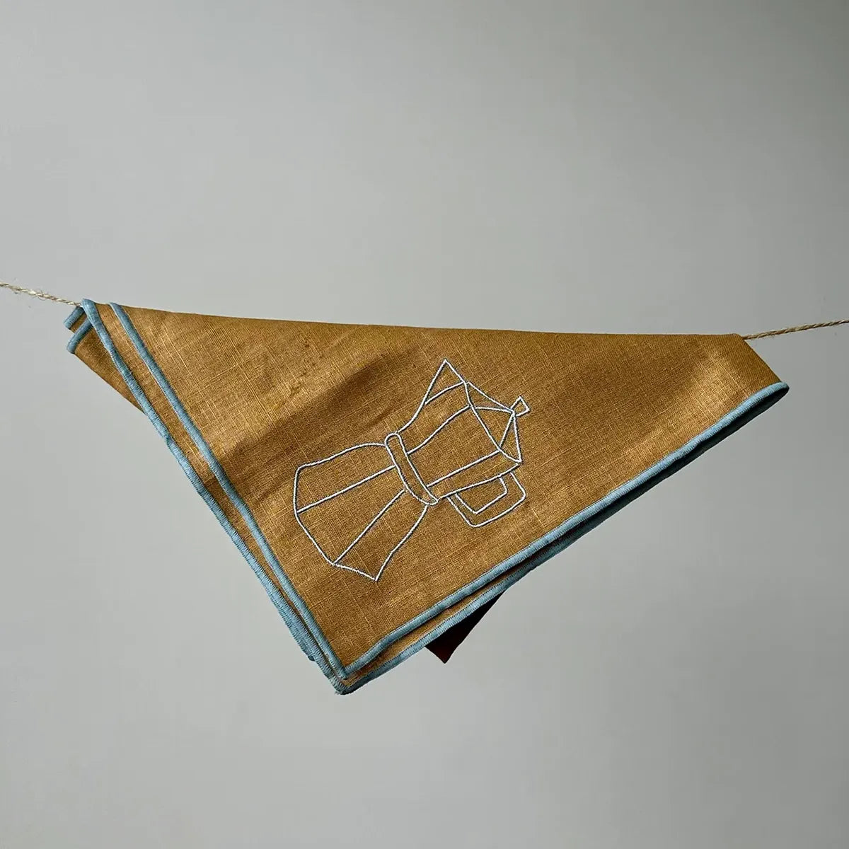 Brown napkin with a blue outline design on a gray background