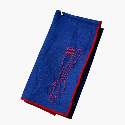 Blue napkin with red outline of a fork and spoon on a white background