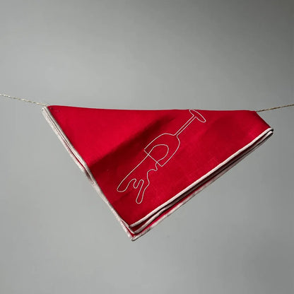 Red napkin with white design on a gray background