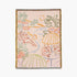 Decorative blanket with colorful beach scene design on a beige background