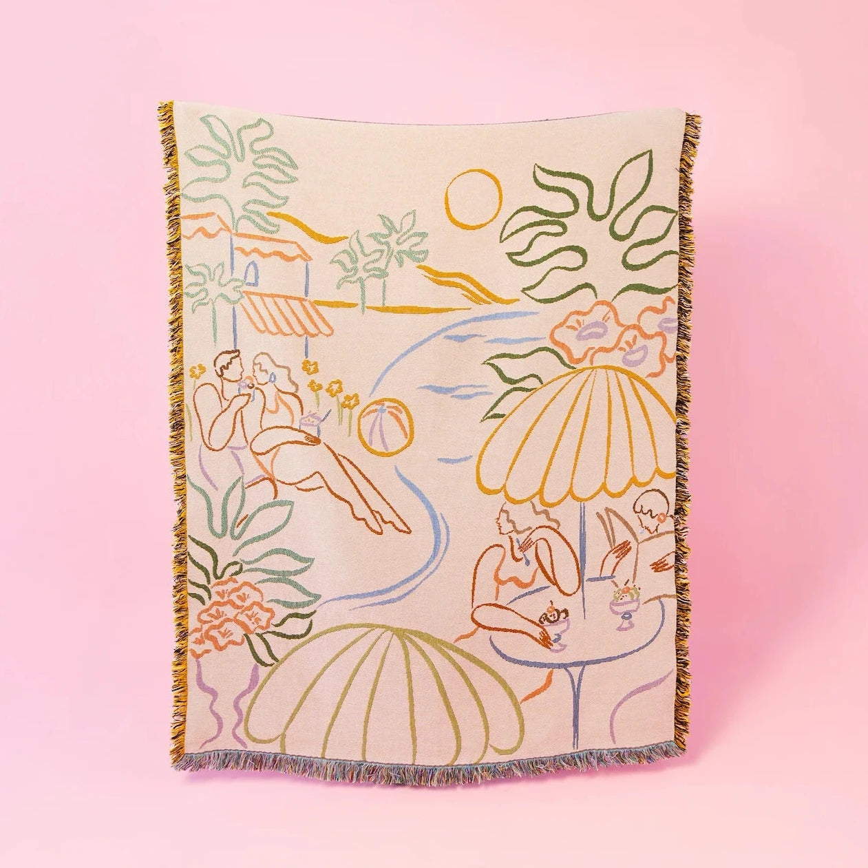 A woven blanket featuring a colorful, abstract beach scene with people lounging under umbrellas, surrounded by plants and a setting sun.