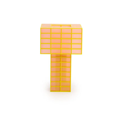 A Ridezign translucent orange and yellow Tesser 5:8 Lamp standing upright on a white background.