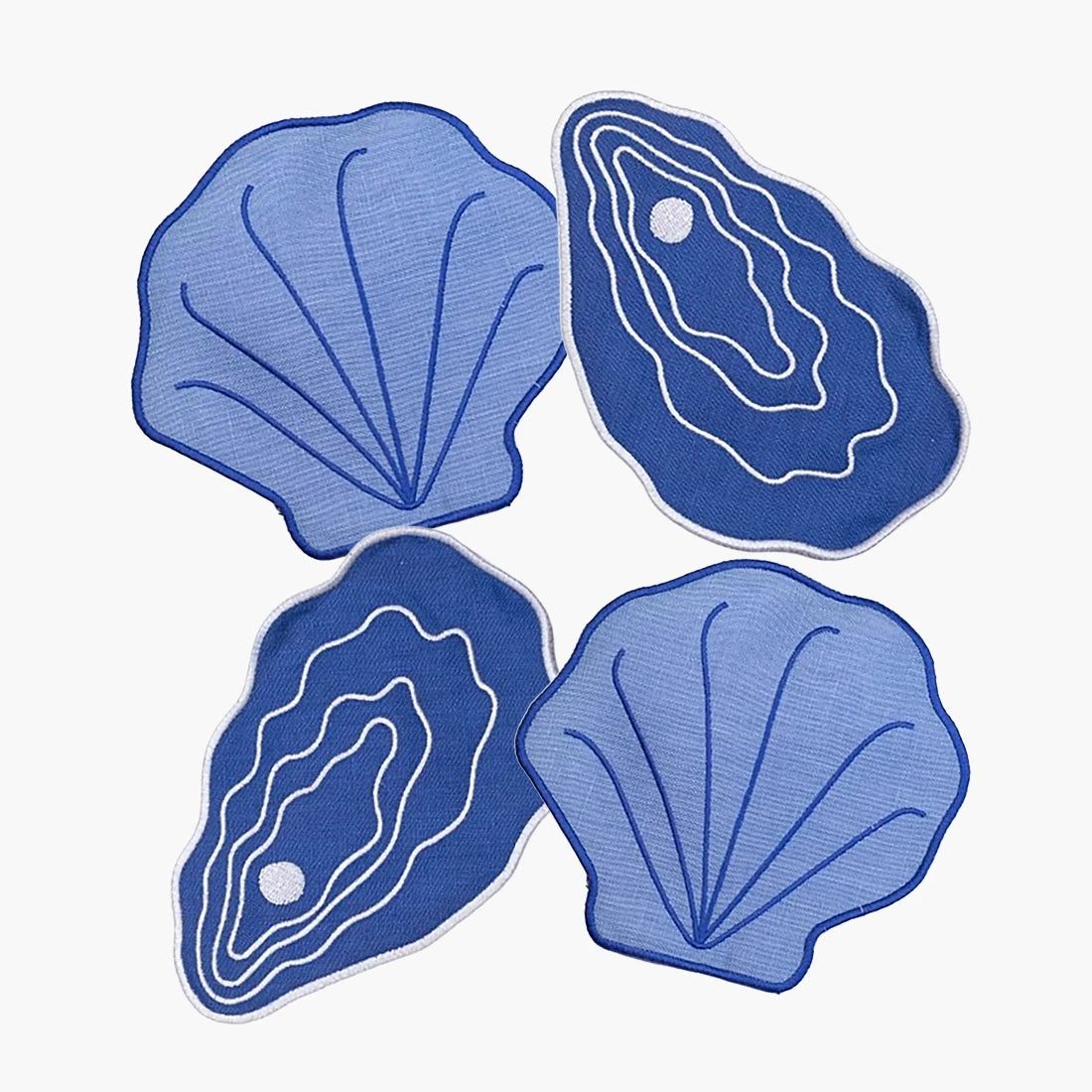 Four blue shell-shaped coasters on a white background