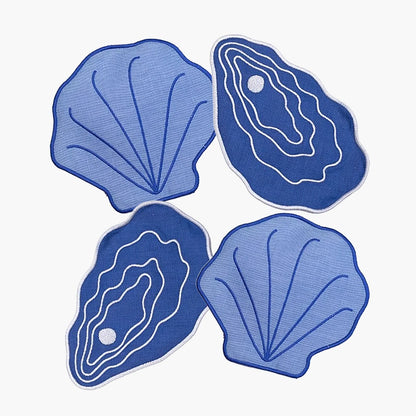 Four blue shell-shaped coasters on a white background