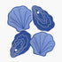 Four blue shell-shaped coasters on a white background