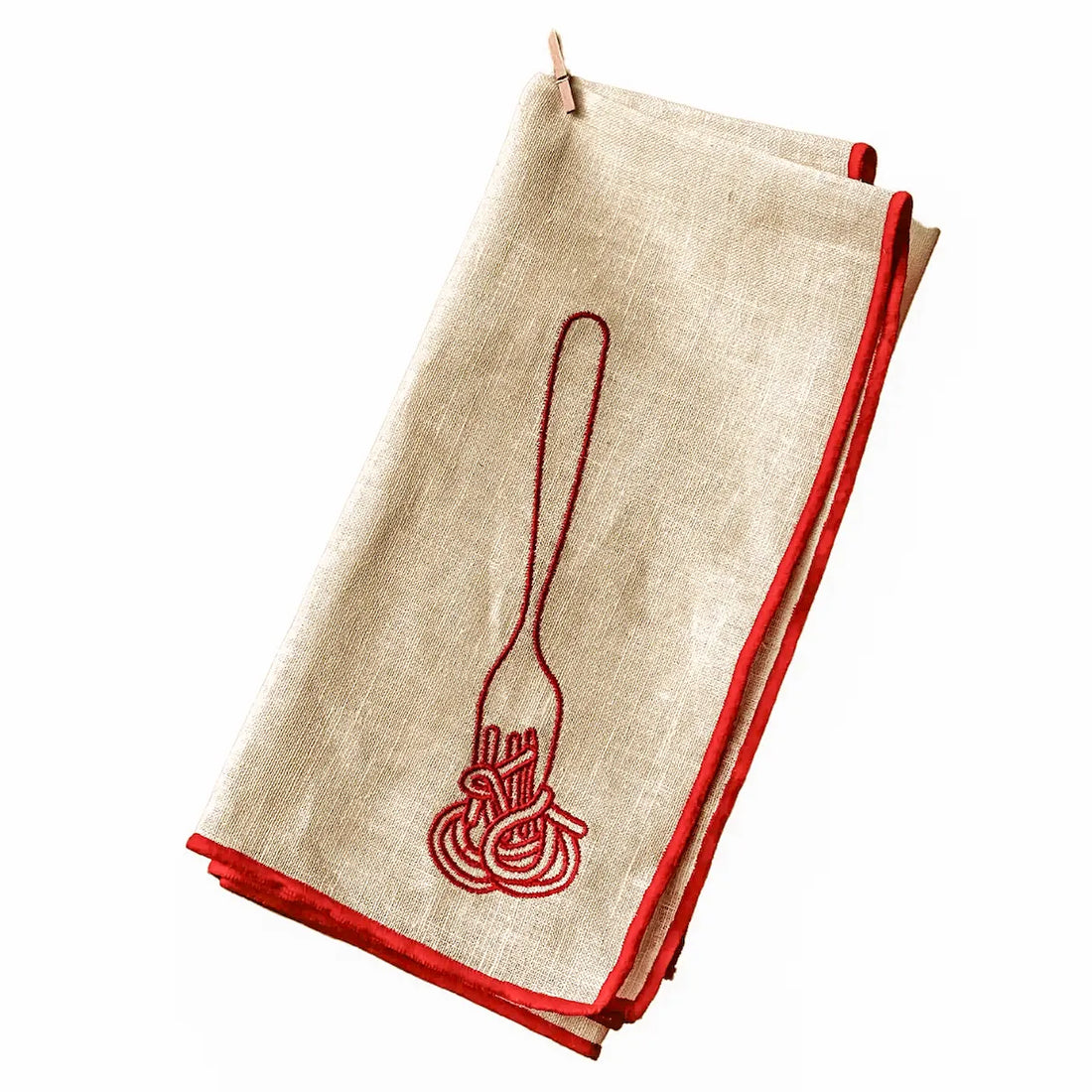 Folded white napkin with red embroidered design on a white background