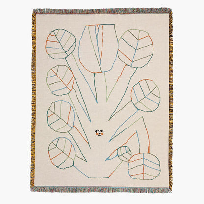 Decorative blanket with abstract leaf pattern on a beige background