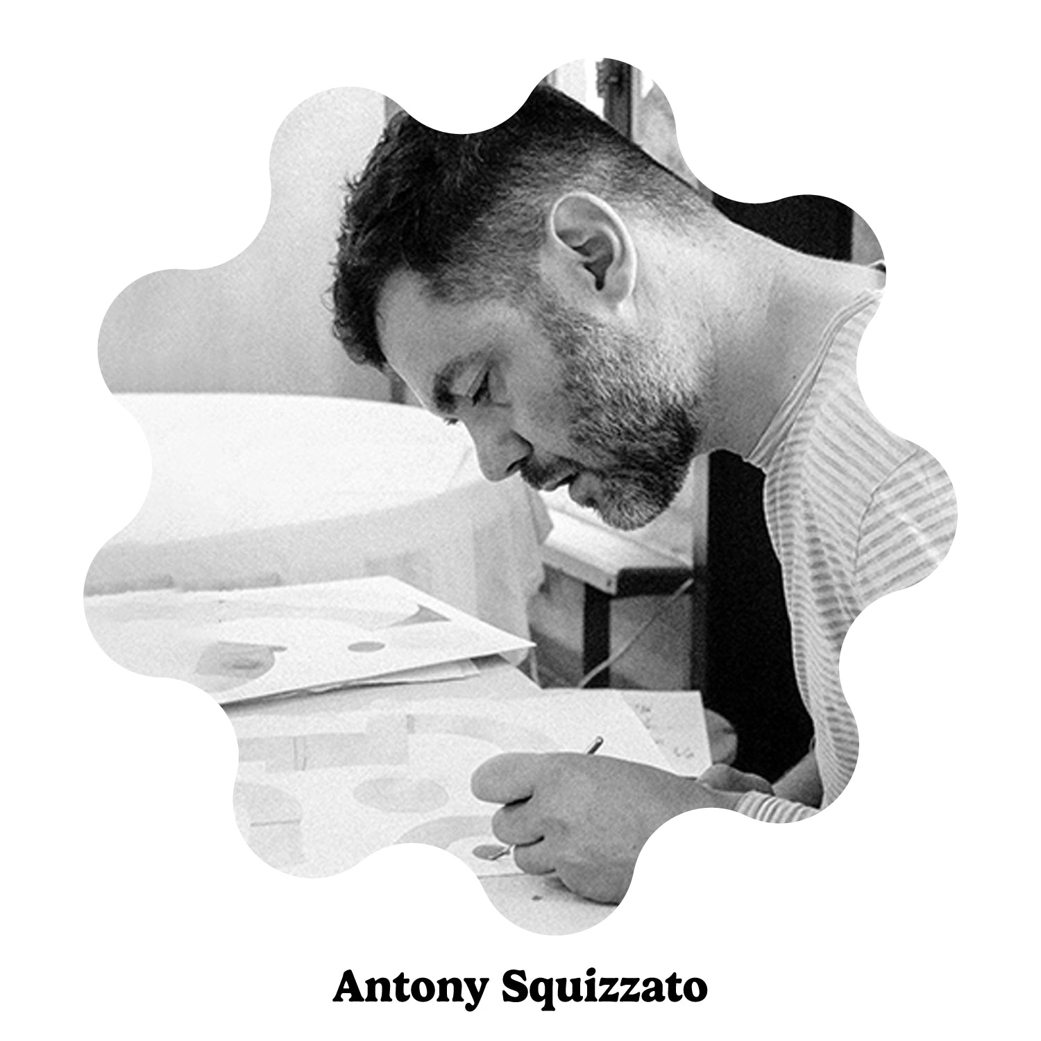 A black and white circular photo of a bearded man, Antony Squizzato, looking down at papers and drawing with a pen. The image is presented on a white background with a scalloped border and the text &